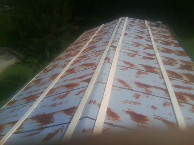 Rusted metal roof panels with new wood purlins before replacement — Storm Damage Roof Repair in Knightstown by Roofing Brothers